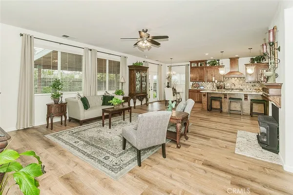 a dining room with furniture a chandelier and wooden floor
