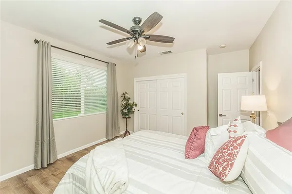 a spacious bedroom with a bed and a chandelier