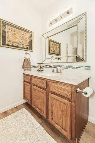 a bathroom with a sink double vanity granite tub shower and a mirror