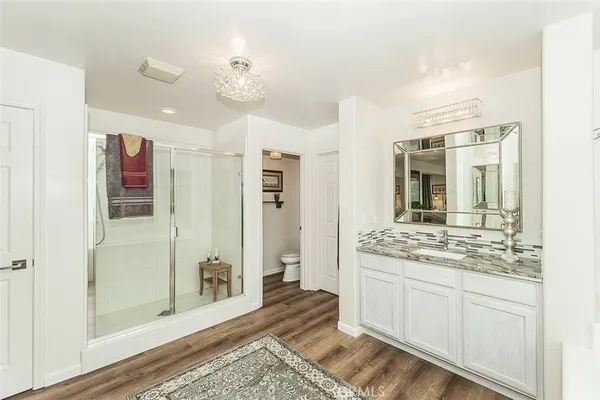 a backyard of a house with fountain table and chairs