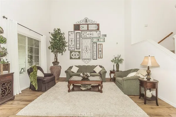 a living room with furniture a fireplace and a potted plant
