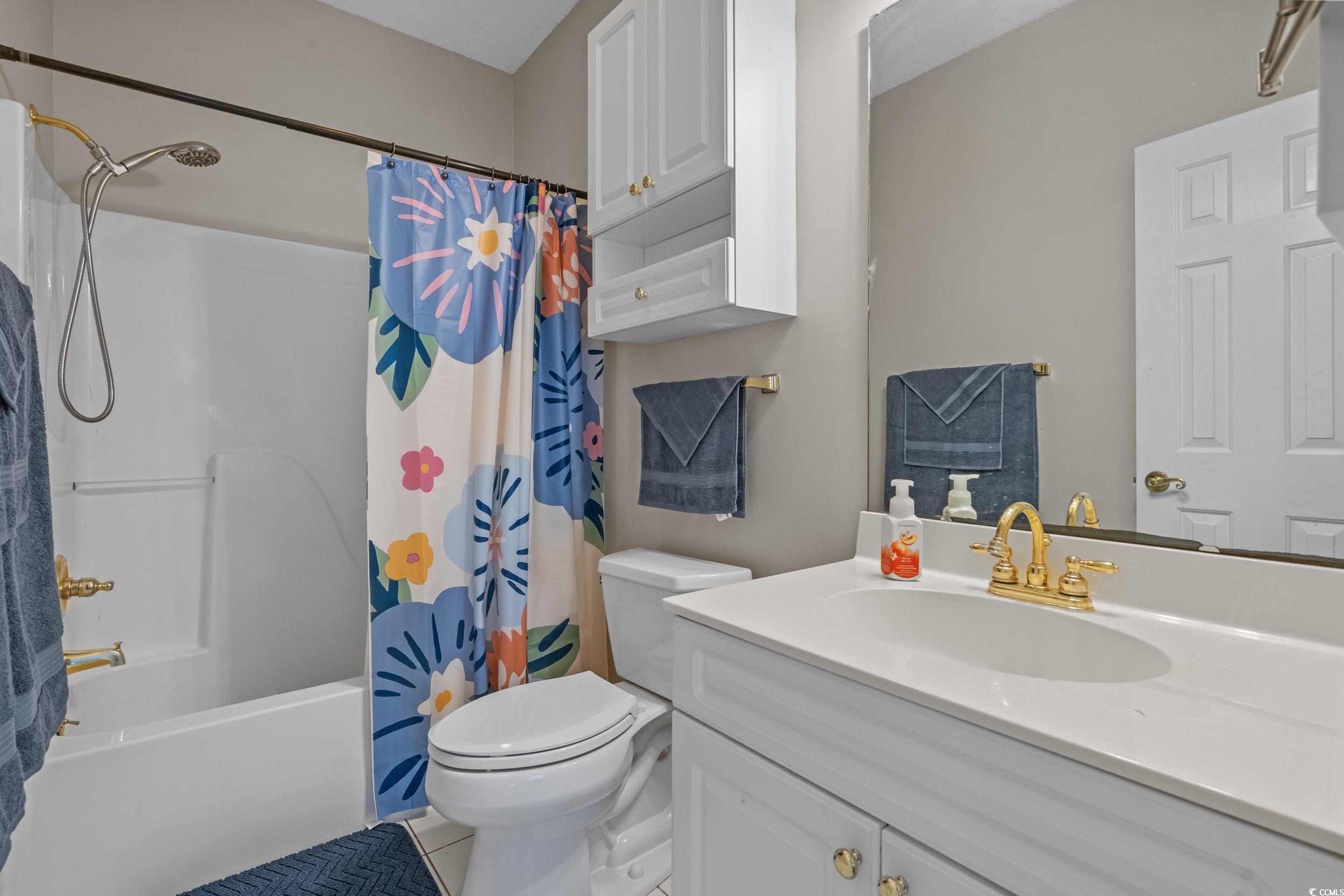 686 Riverwalk Drive, Unit 204 Myrtle Beach, SC 29579 - Photo 18 of 40 Bathroom with shower / tub combo with curtain, tile patterned floors, and vanity