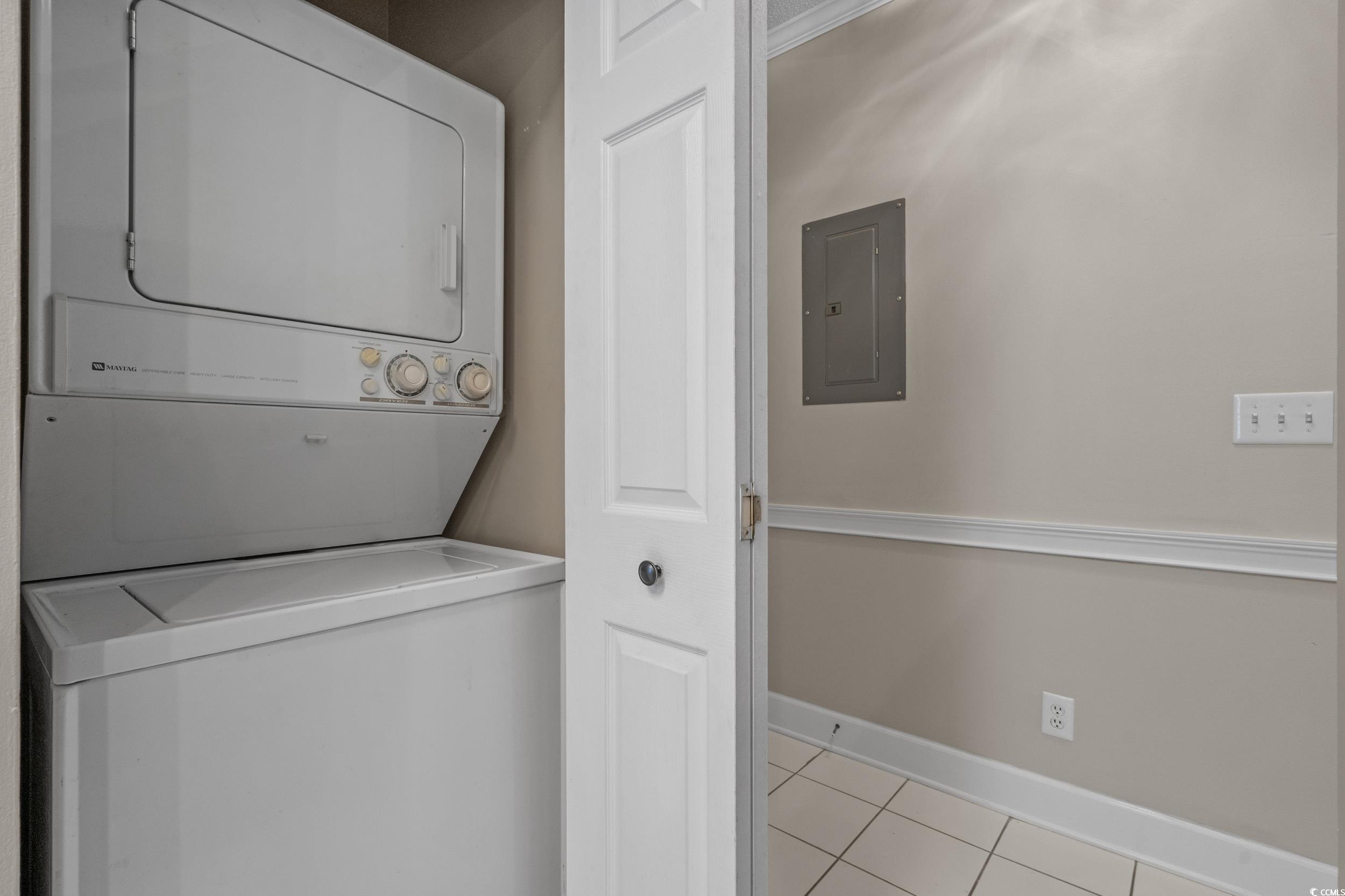 686 Riverwalk Drive, Unit 204 Myrtle Beach, SC 29579 - Photo 23 of 40 Laundry room with light tile patterned floors, electric panel, and estacked washer and dryer
