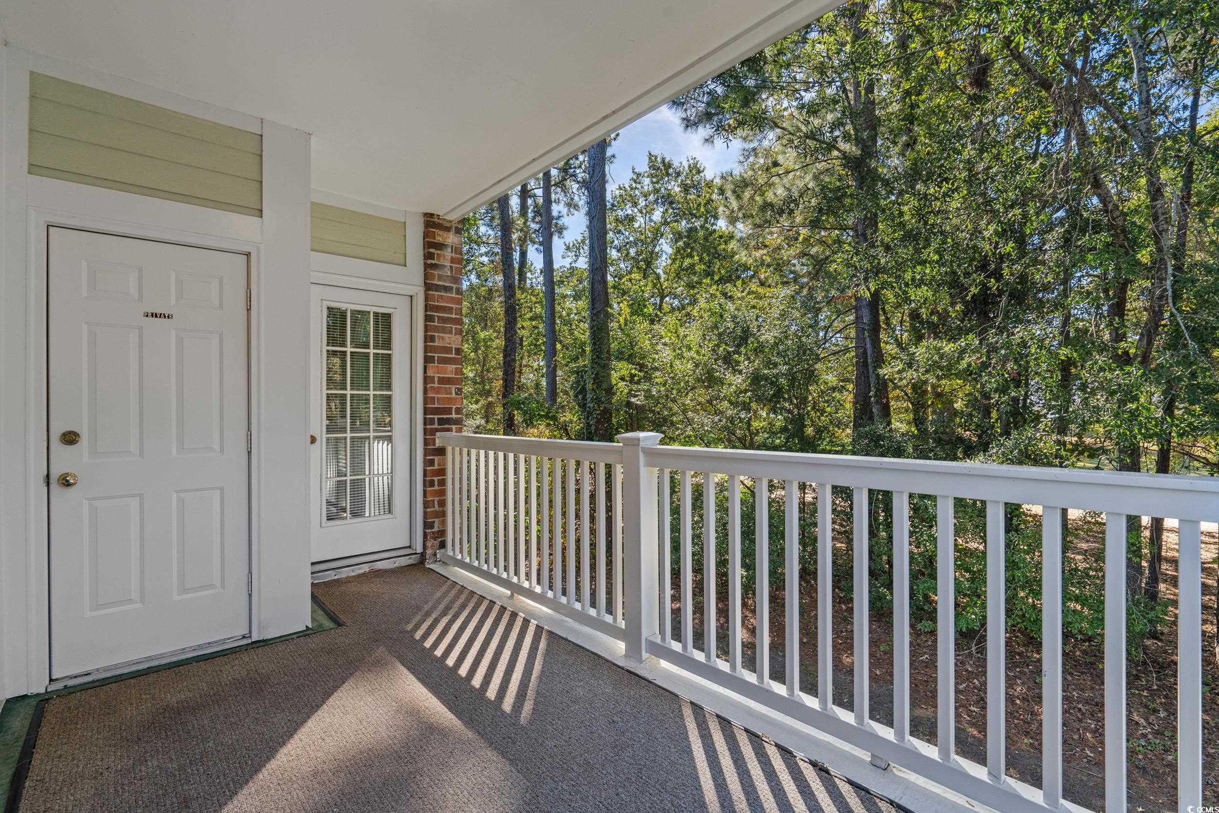 686 Riverwalk Drive, Unit 204 Myrtle Beach, SC 29579 - Photo 26 of 40 Balcony featuring view of wooded area