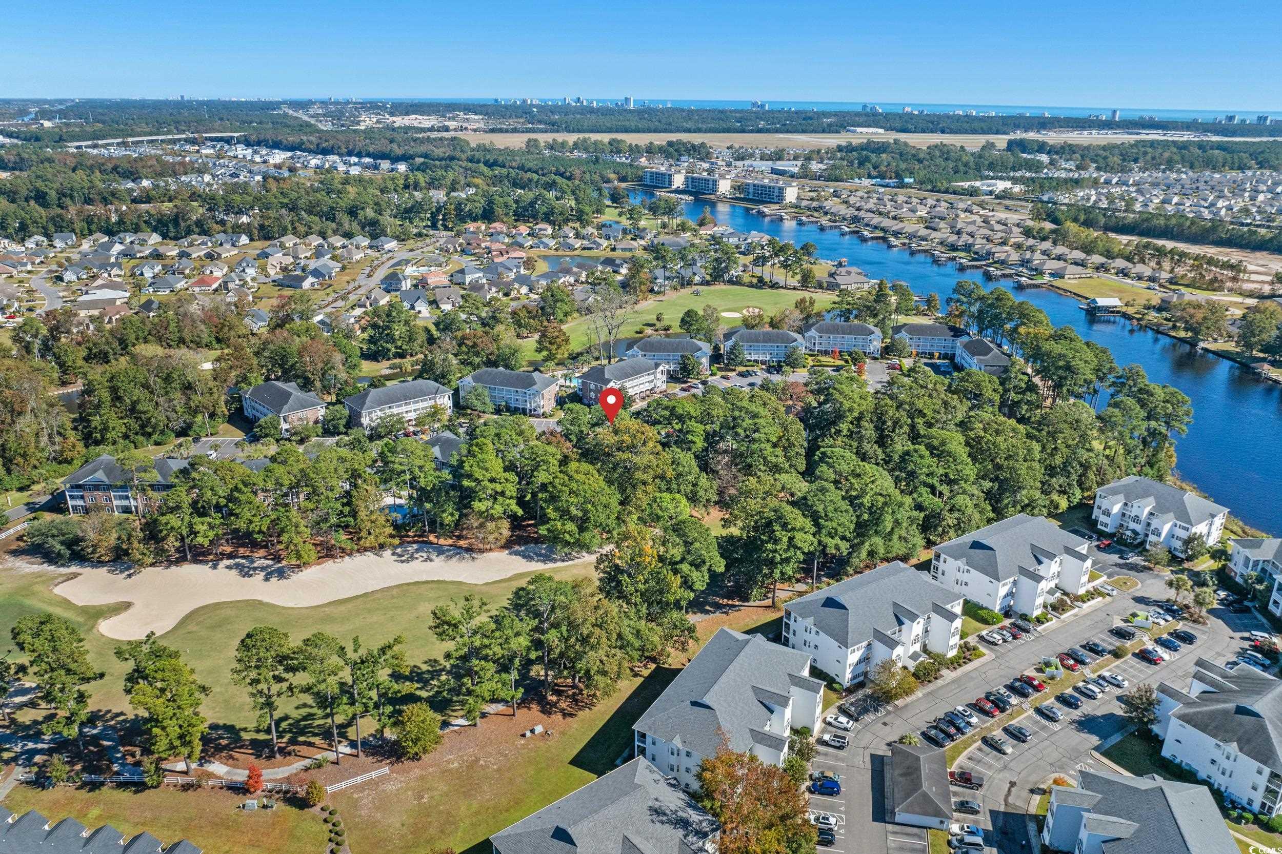 686 Riverwalk Drive, Unit 204 Myrtle Beach, SC 29579 - Photo 27 of 40 Aerial perspective of suburban area with a nearby body of water and a tree filled landscape