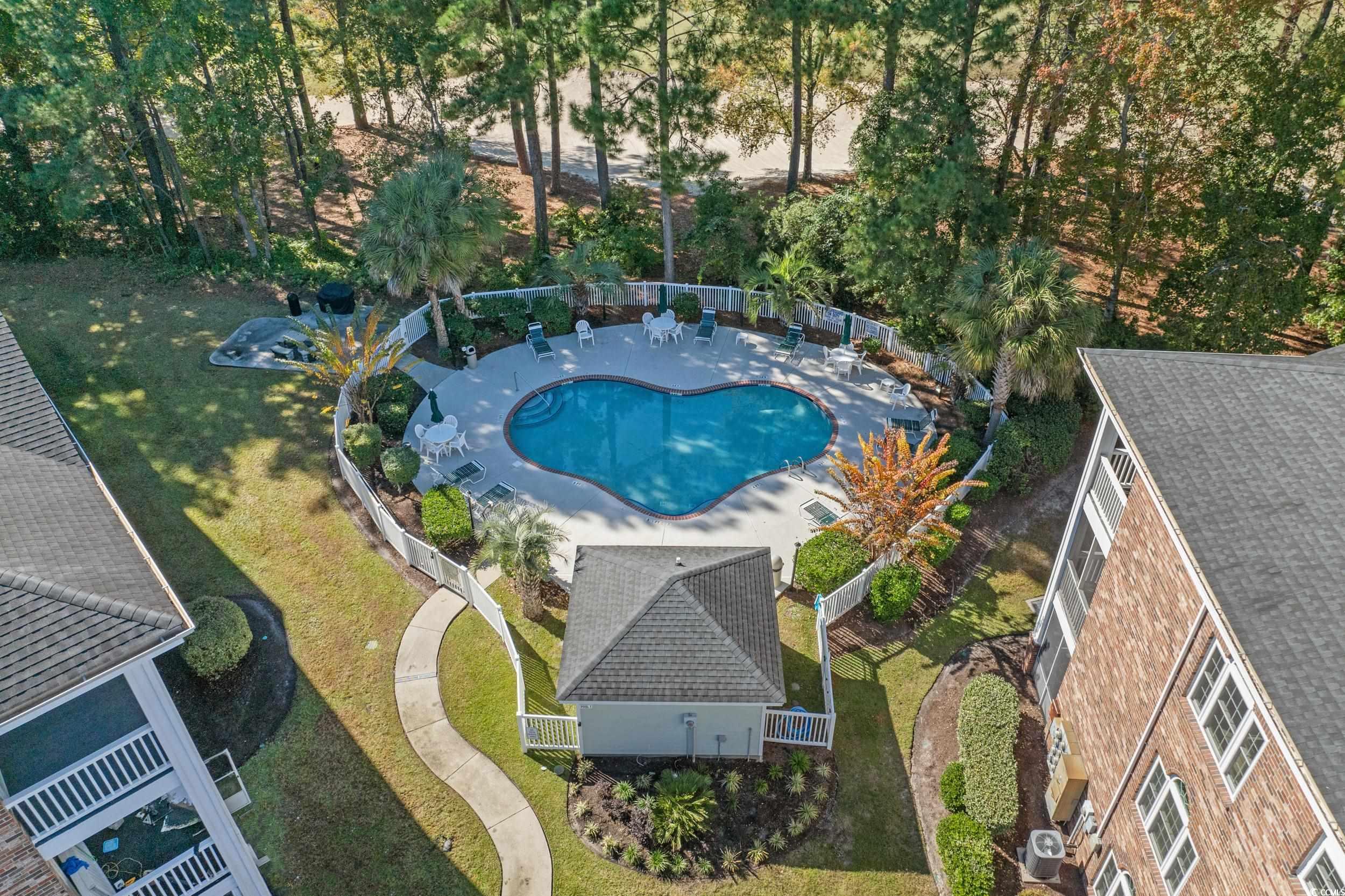 686 Riverwalk Drive, Unit 204 Myrtle Beach, SC 29579 - Photo 30 of 40 Community pool with a fenced backyard, a patio area, and view of wooded area
