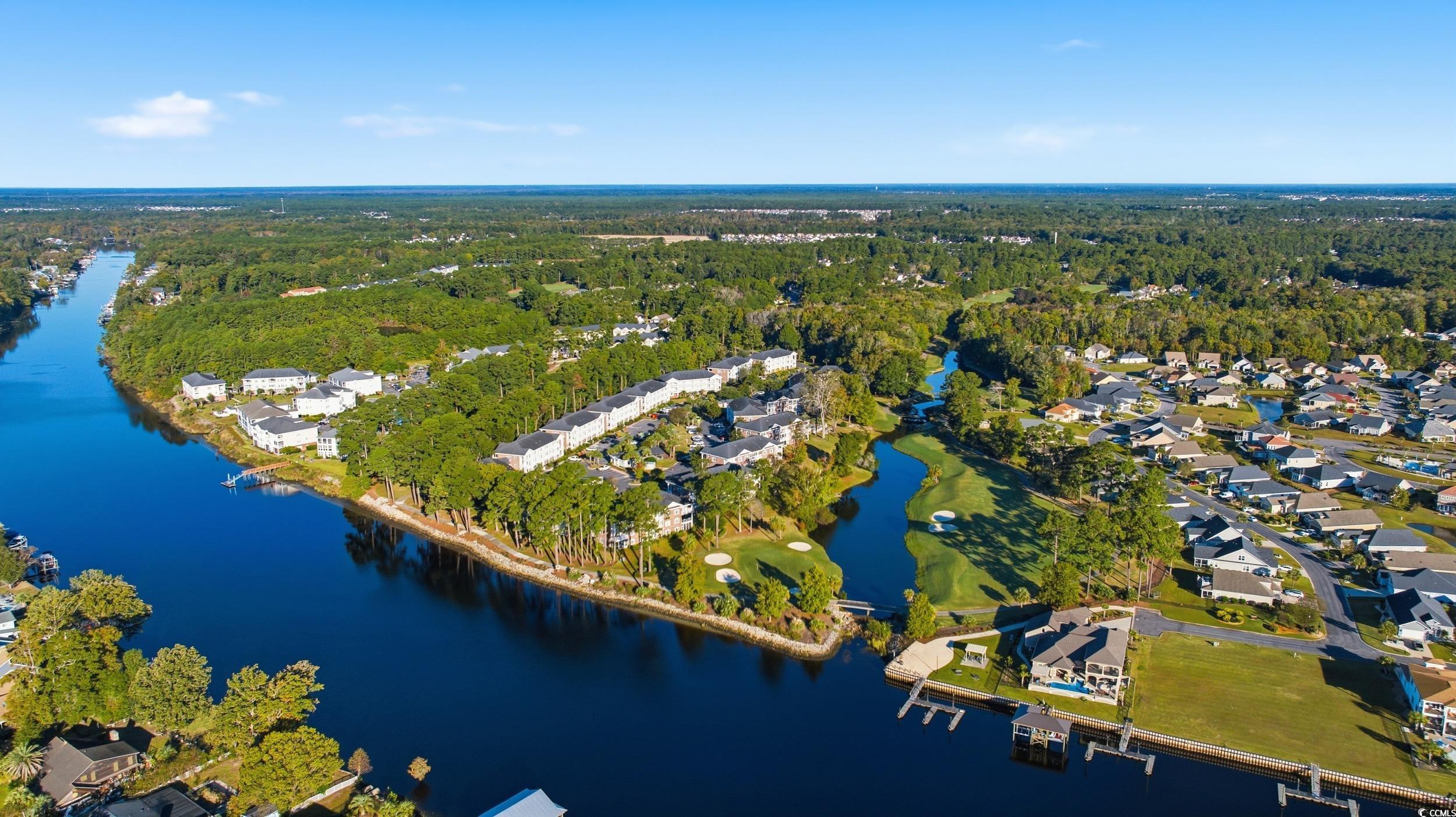 686 Riverwalk Drive, Unit 204 Myrtle Beach, SC 29579 - Photo 35 of 40 Aerial view of property and surrounding area featuring a large body of water and nearby suburban area
