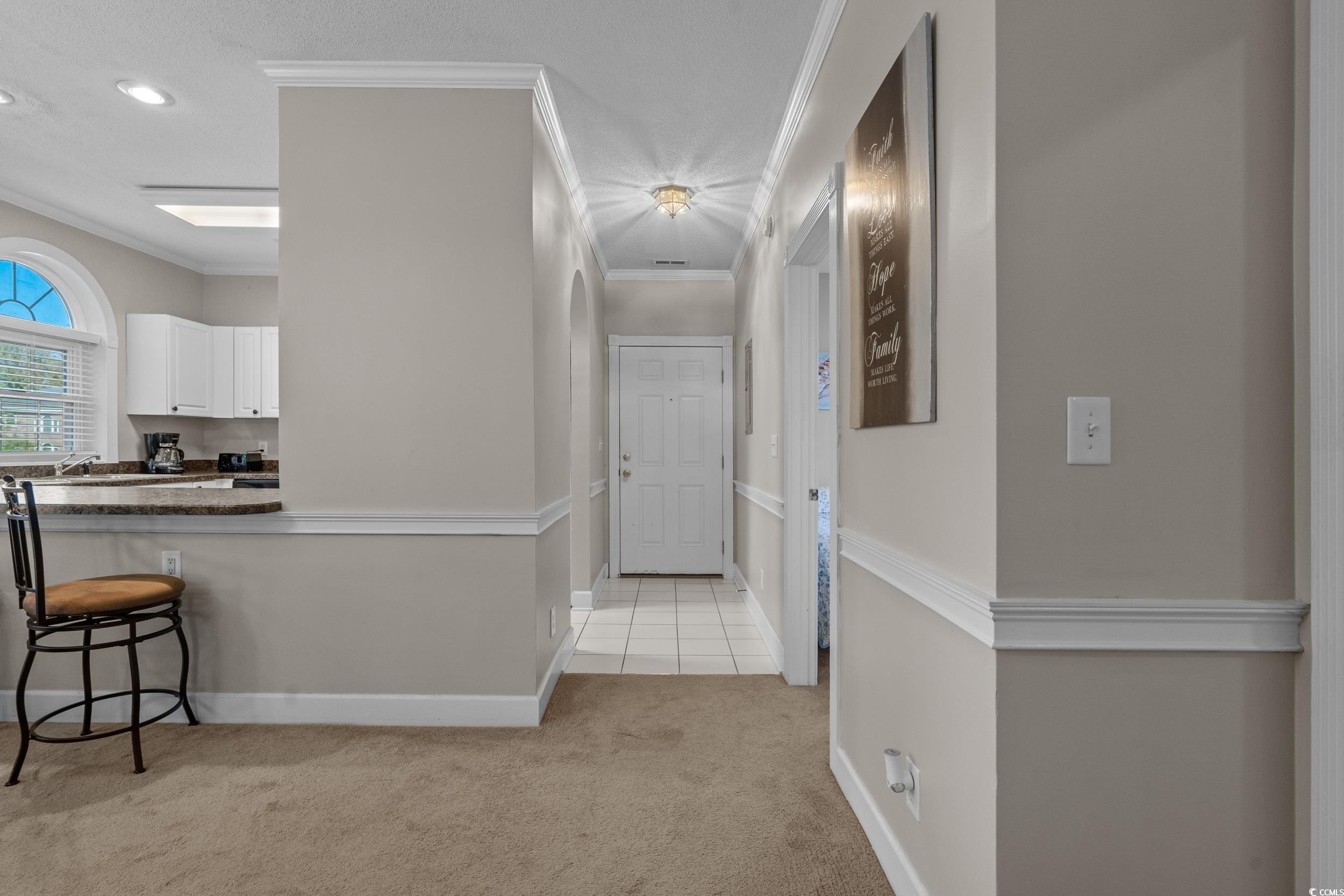 686 Riverwalk Drive, Unit 204 Myrtle Beach, SC 29579 - Photo 4 of 40 Hall with ornamental molding, light colored carpet, light tile patterned floors, and recessed lighting