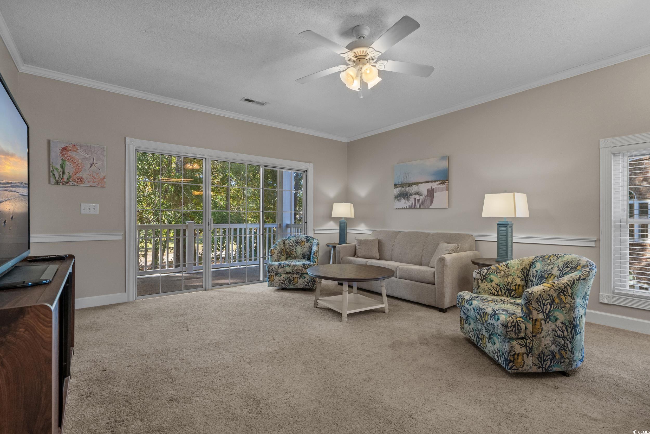 686 Riverwalk Drive, Unit 204 Myrtle Beach, SC 29579 - Photo 7 of 40 Living area with ornamental molding, light colored carpet, and ceiling fan