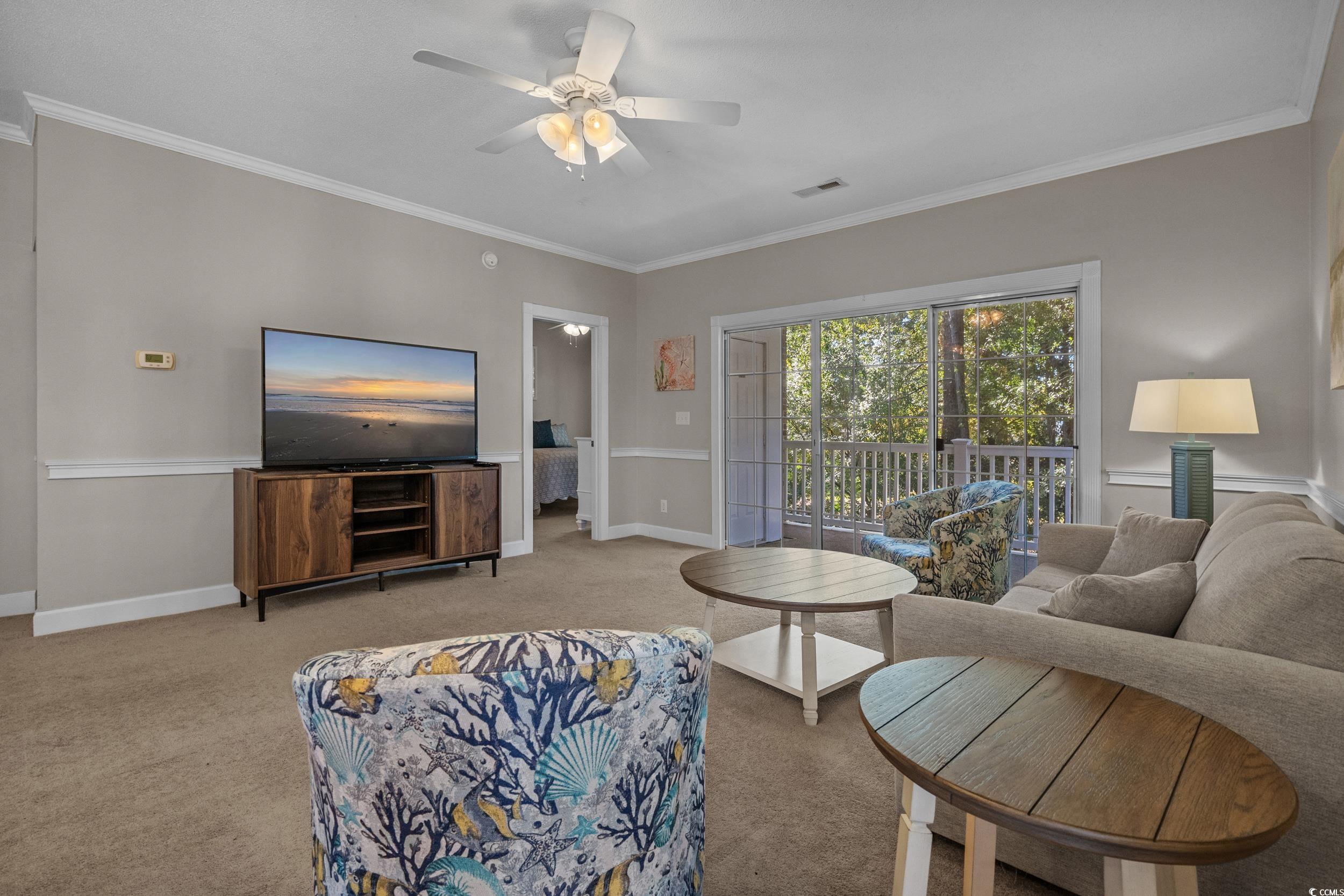 686 Riverwalk Drive, Unit 204 Myrtle Beach, SC 29579 - Photo 8 of 40 Carpeted living area with crown molding and ceiling fan