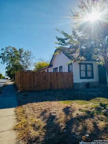 a view of a house with wooden fence