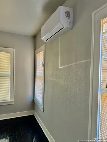 a bathroom with a window and a shower