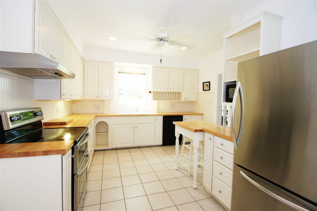 435 Baynes Road Waynesboro, VA 22980 - Photo 14 of 35 a kitchen with a sink a stove a refrigerator and white cabinets