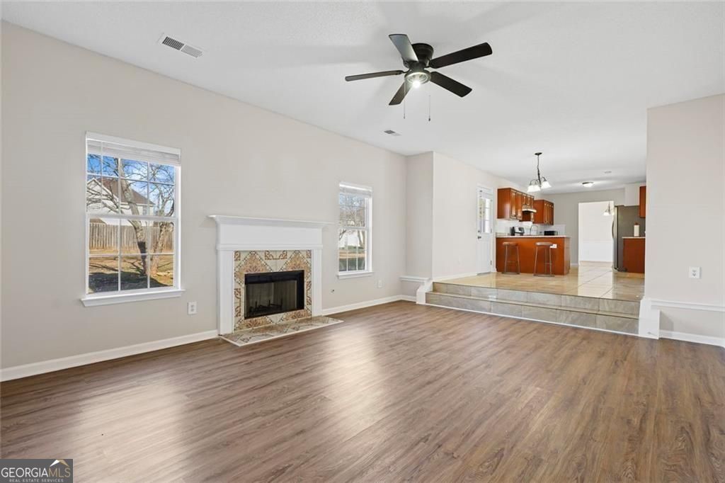 2320 Highbank Court Decatur, GA 30035 - Photo 11 of 27 an empty room with wooden floor fireplace and a window