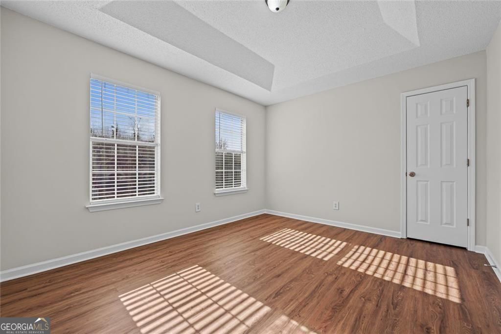 2320 Highbank Court Decatur, GA 30035 - Photo 18 of 27 a view of an empty room with wooden floor and a window