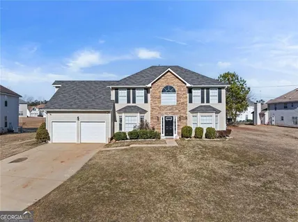 a front view of a house with a yard