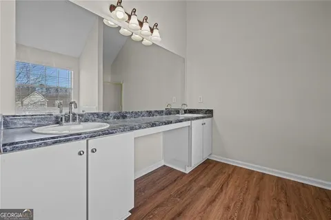 a bathroom with a sink vanity and a mirror