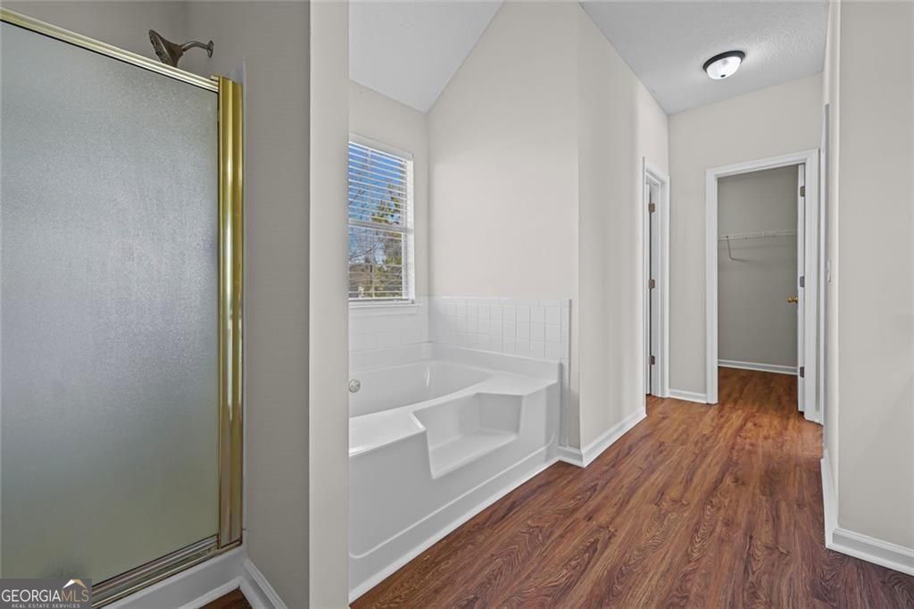 2320 Highbank Court Decatur, GA 30035 - Photo 23 of 27 a bathroom with a wooden floor and a shower
