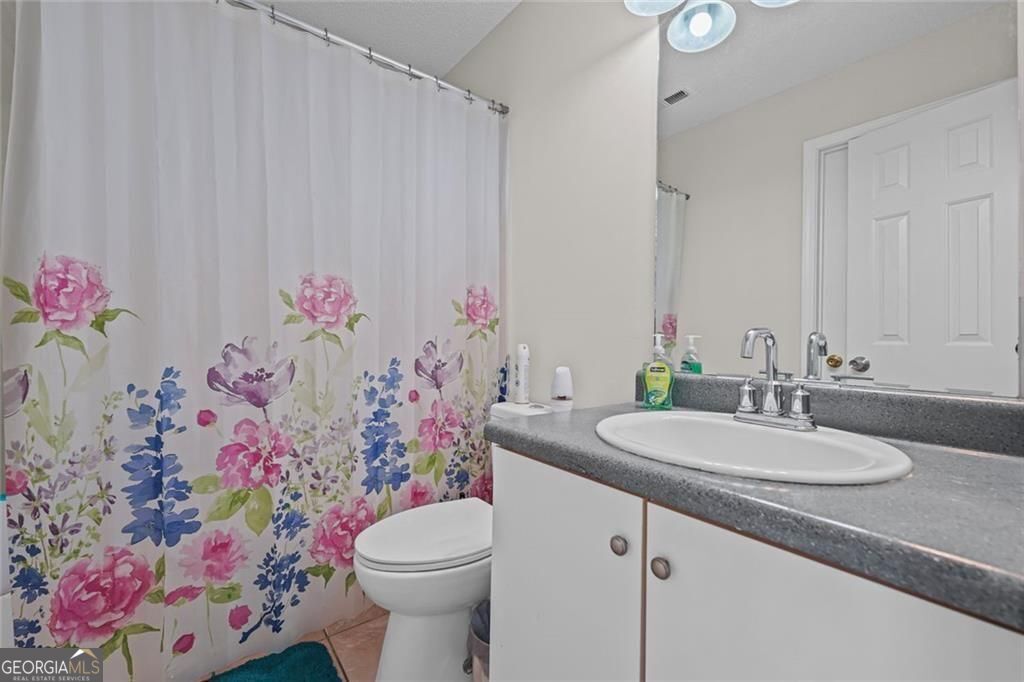 2320 Highbank Court Decatur, GA 30035 - Photo 25 of 27 a bathroom with a sink vanity and toilet