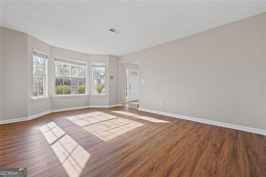 2320 Highbank Court Decatur, GA 30035 - Photo 5 of 27 a view of an empty room with wooden floor and a window