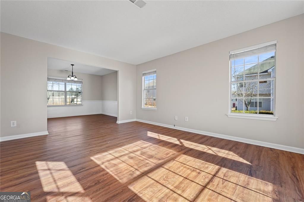2320 Highbank Court Decatur, GA 30035 - Photo 6 of 27 a view of an empty room with window and wooden floor