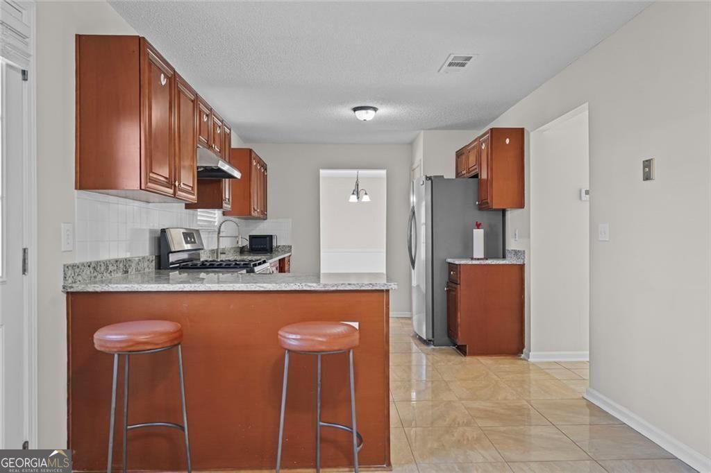 2320 Highbank Court Decatur, GA 30035 - Photo 7 of 27 a kitchen with stainless steel appliances granite countertop a refrigerator and a stove top oven