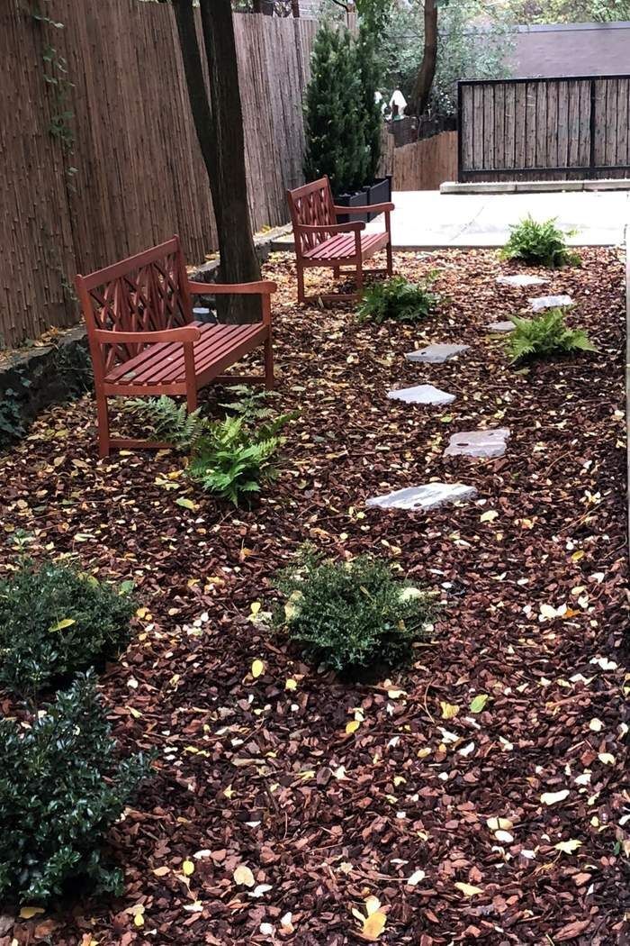 225 East 74th Street, Unit 2M Manhattan, NY 10021 - Photo 15 of 16 a view of a backyard with plants and a bench