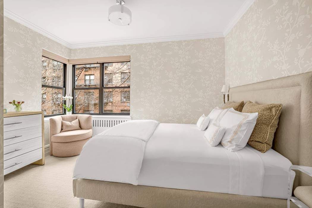 225 East 74th Street, Unit 2M Manhattan, NY 10021 - Photo 6 of 16 a bedroom with a bed and a large window