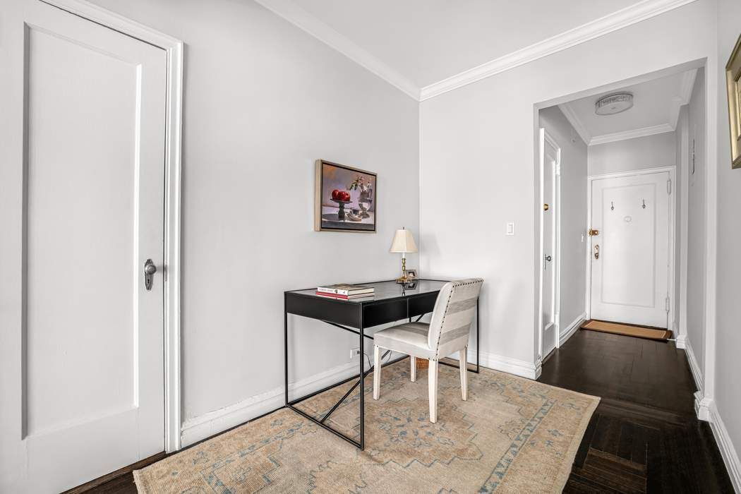 225 East 74th Street, Unit 2M Manhattan, NY 10021 - Photo 9 of 16 a living room with a couch and a coffee table