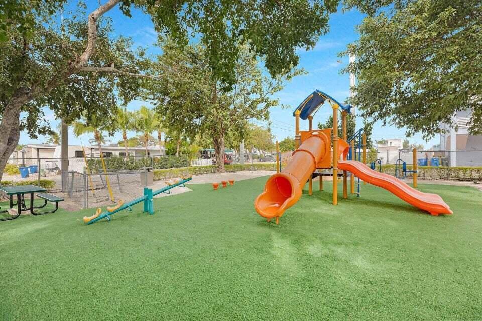 325 Calusa Street, Unit 413 Key Largo, FL 33037 - Photo 18 of 27 a view of a playground with a slide and swing