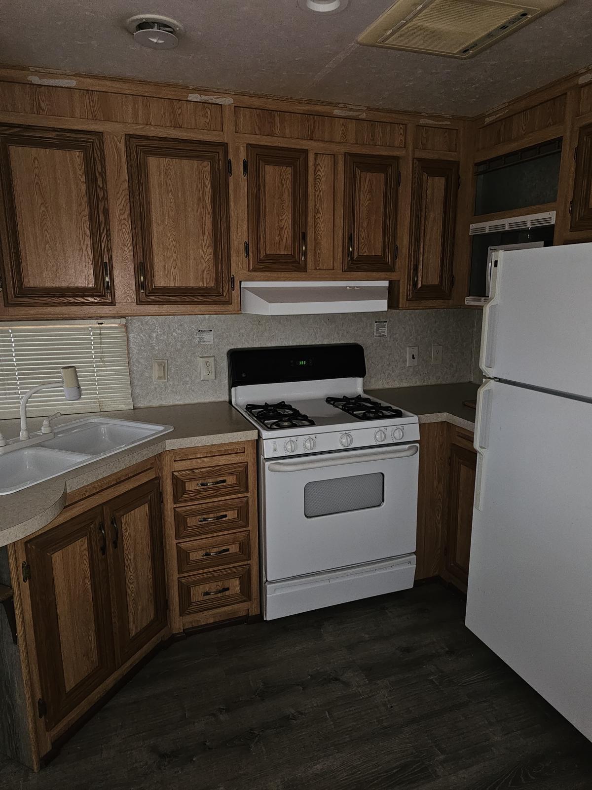 325 Calusa Street, Unit 413 Key Largo, FL 33037 - Photo 2 of 27 a kitchen with granite countertop a sink stainless steel appliances and cabinets