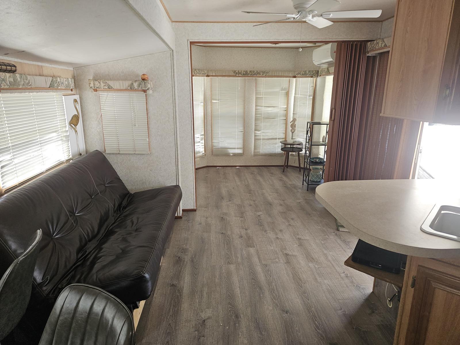 325 Calusa Street, Unit 413 Key Largo, FL 33037 - Photo 3 of 27 a living room with furniture and a table