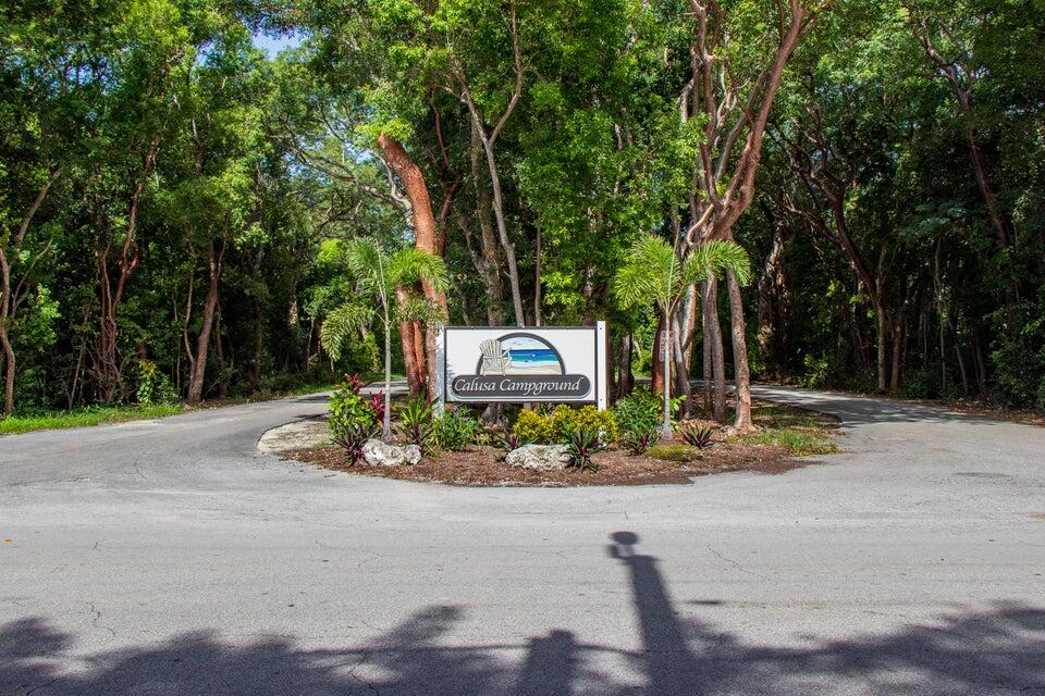 325 Calusa Street, Unit 413 Key Largo, FL 33037 - Photo 10 of 27 a front view of a house with a yard and trees
