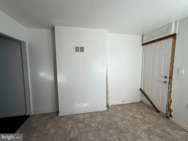 a view of an empty room with a cabinet