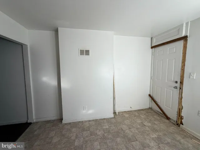 a view of an empty room with a cabinet