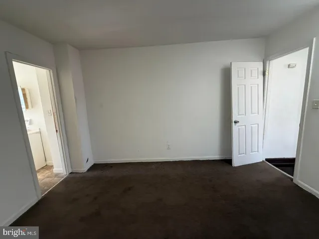 a view of an empty room and a window