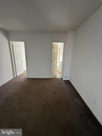 a white bath tub sitting in a bathroom next to a window