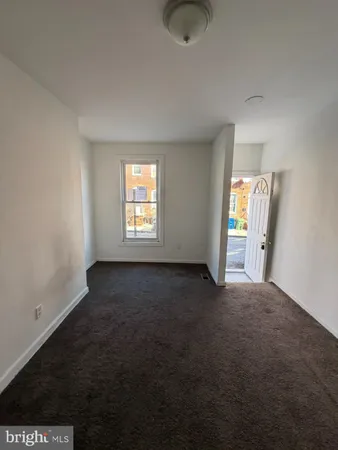 a view of an empty room and wooden floor