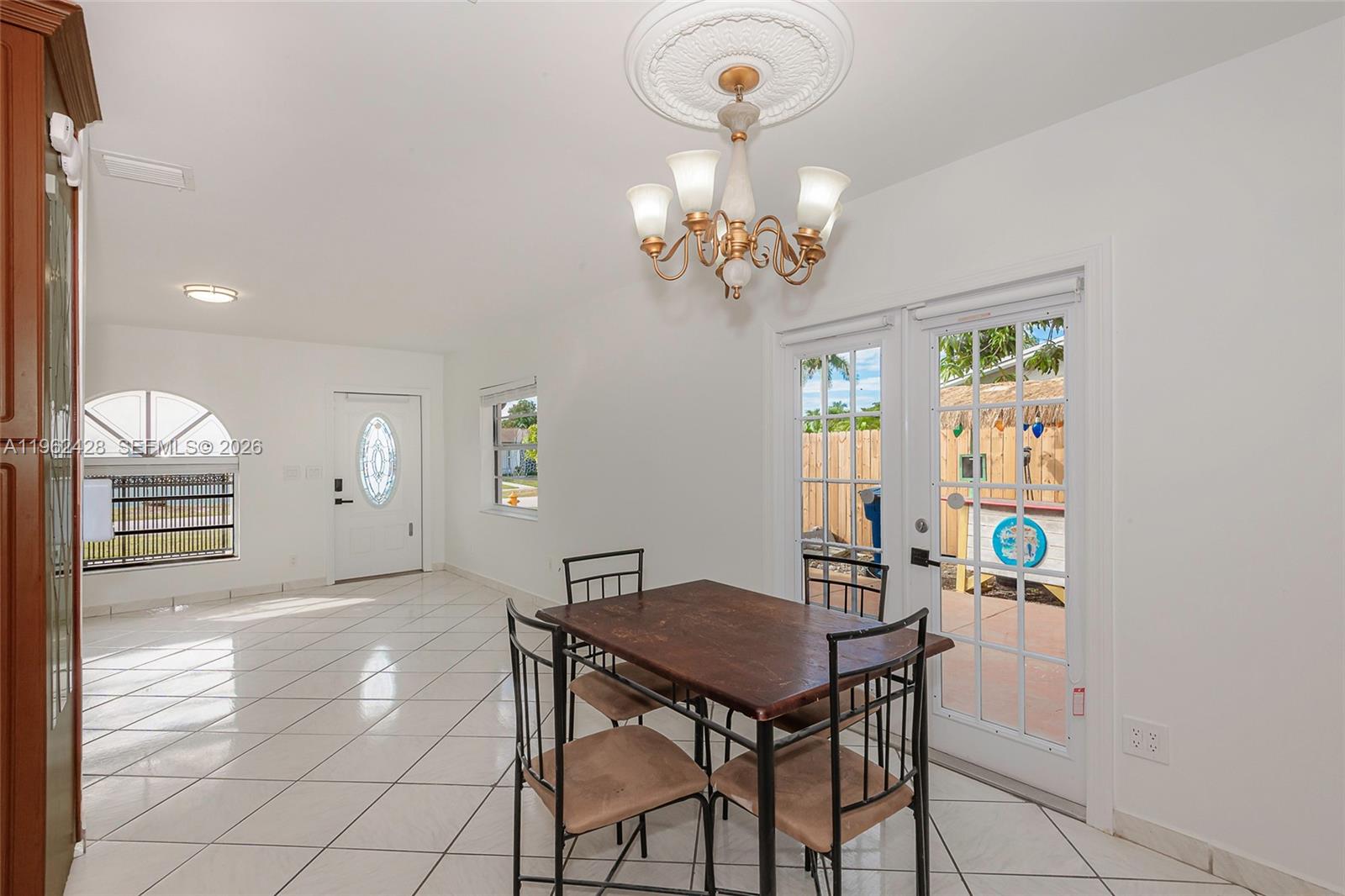 11941 Southwest 178th Terrace Miami, FL 33177 - Photo 13 of 33 a view of a dining room with furniture and chandelier