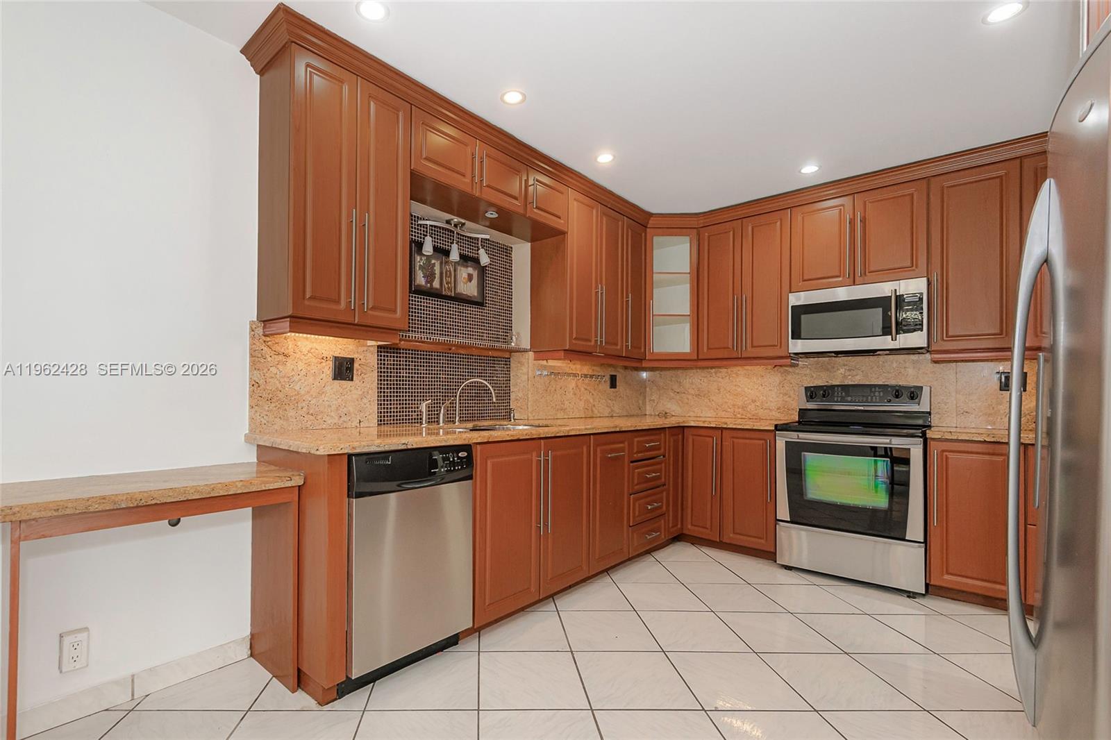 11941 Southwest 178th Terrace Miami, FL 33177 - Photo 9 of 33 a kitchen with stainless steel appliances granite countertop a stove top oven a sink and dishwasher