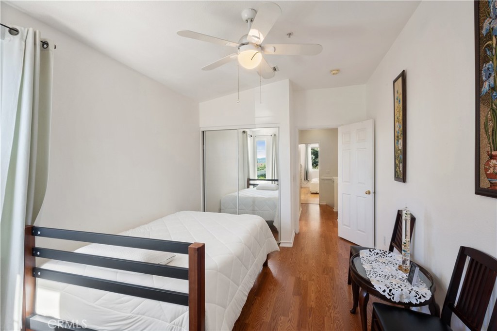 1517 Ismail Place Placentia, CA 92870 - Photo 16 of 28 a bedroom with a bed and a chair with the wooden floor