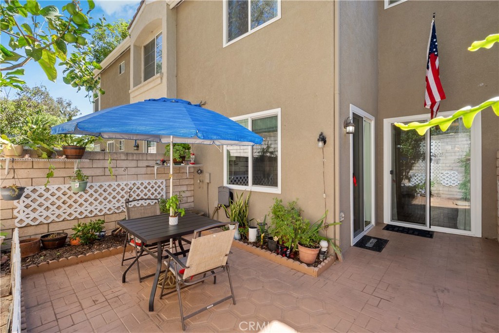1517 Ismail Place Placentia, CA 92870 - Photo 19 of 28 a view of a patio with table and chairs under an umbrella