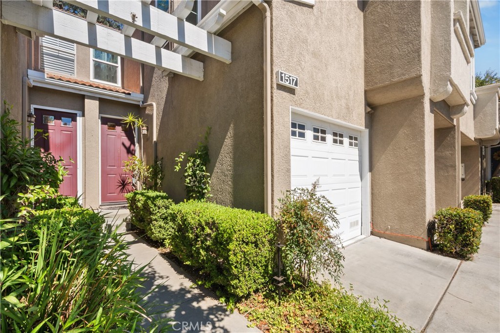 1517 Ismail Place Placentia, CA 92870 - Photo 20 of 28 front view of a brick house with a flower plants