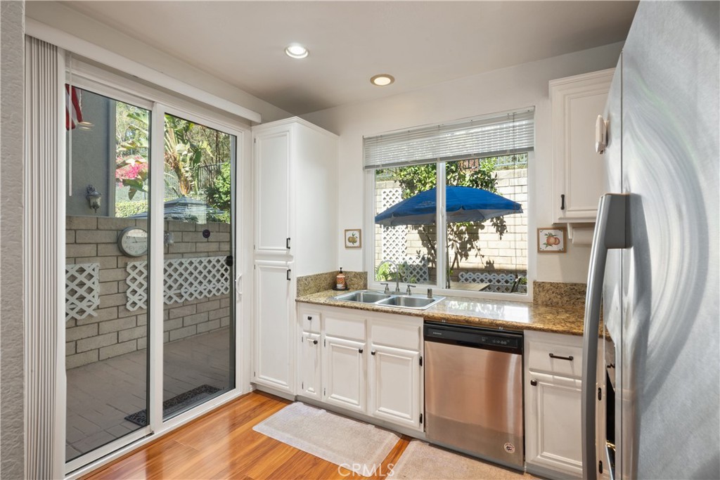 1517 Ismail Place Placentia, CA 92870 - Photo 8 of 28 a kitchen with stainless steel appliances granite countertop a refrigerator and a sink