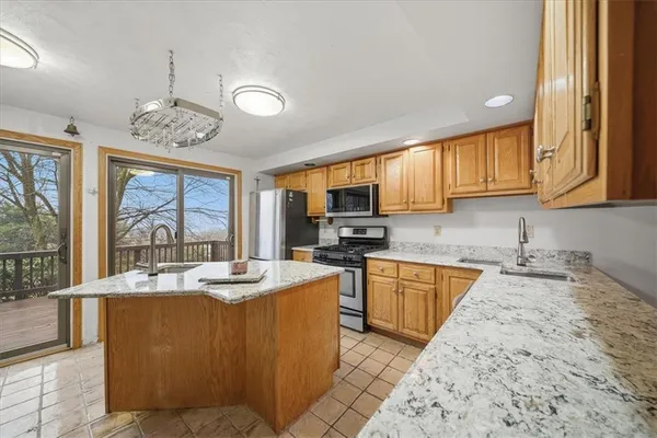 a kitchen with granite countertop a sink stove and cabinets