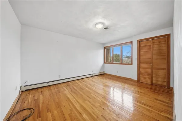 wooden floor in an empty room with a window