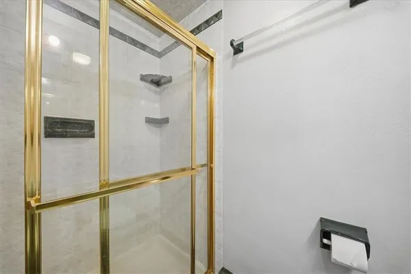 a bathroom with a glass shower door