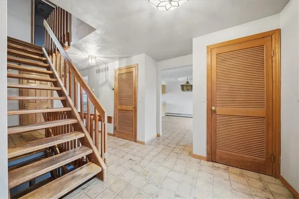 a view of entryway with wooden floor and stairs