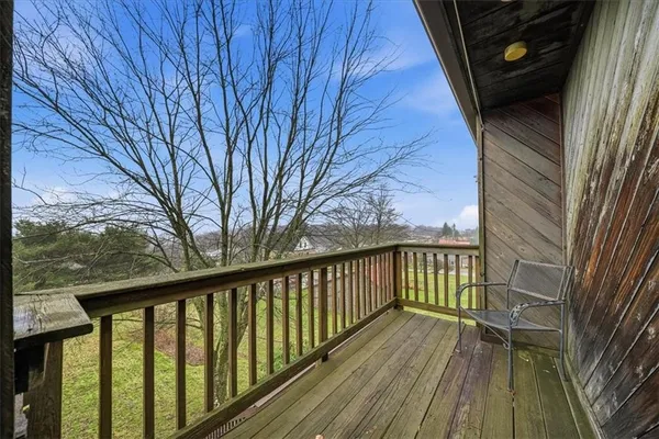 a view of a balcony with wooden floor