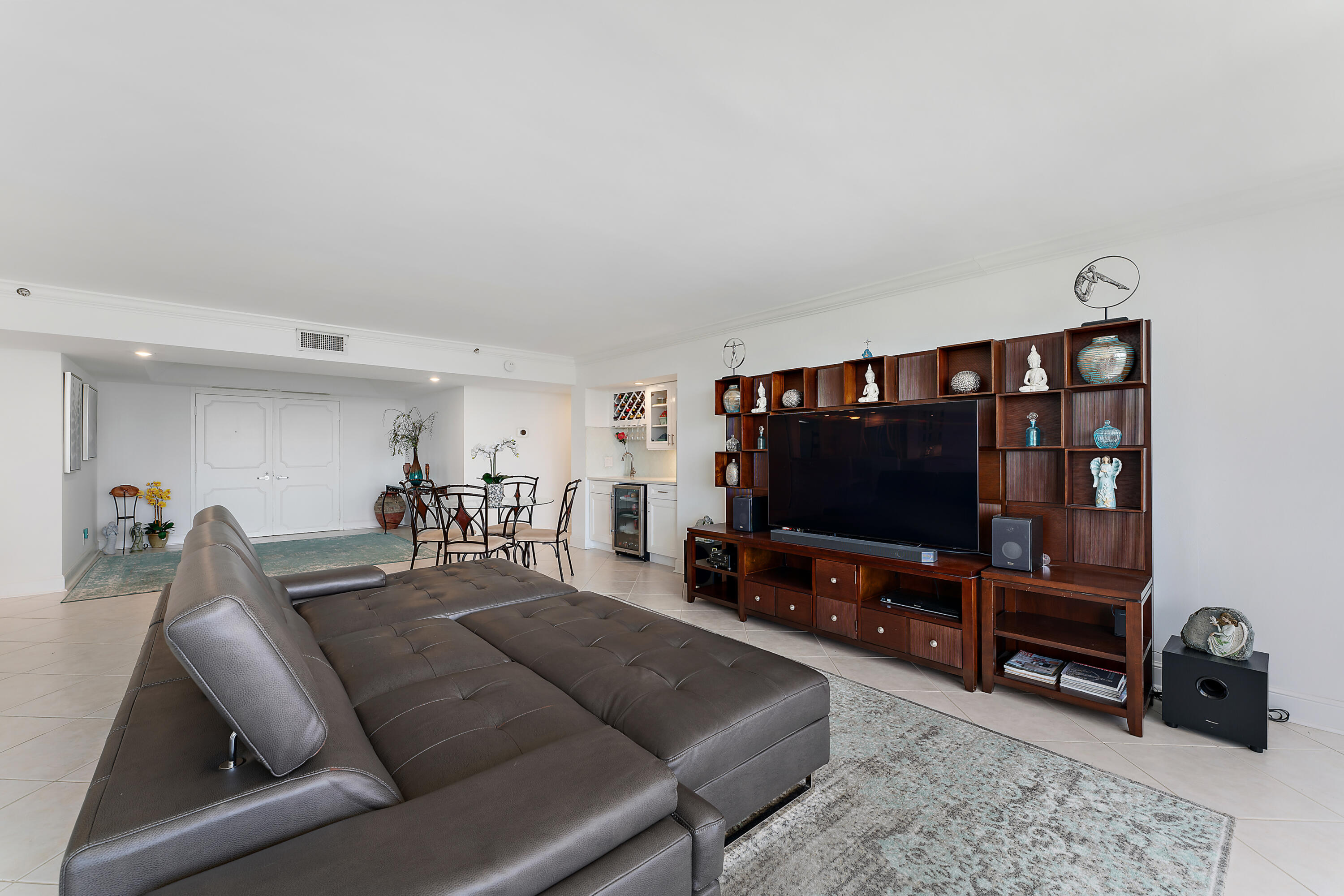 5280 North Ocean Drive, Unit 2F Singer Island, FL 33404 - Photo 11 of 92 a living room with furniture and a flat screen tv